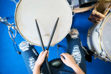 a person playing on the drums