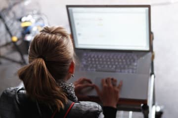 Script supervisor taking notes on computer