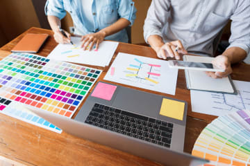 two graphic designers working on a website redesign