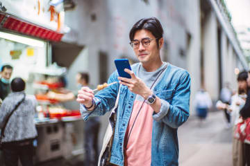 Social influencer taking photo of food for social media