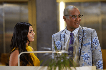 man and woman discuss accounting in office setting