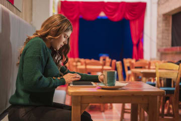 Woman posting on social media in cafe