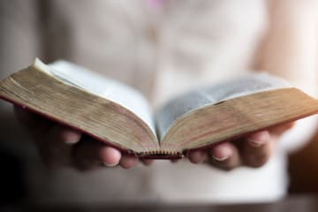Woman holding Bible in her hands