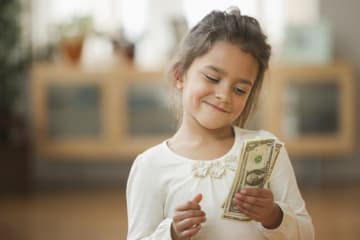 Little girl holding money