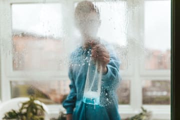 Man cleaning glass window