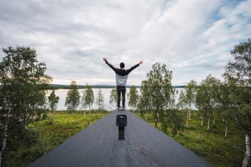 Man standing on roof with hand raised toward Heaven