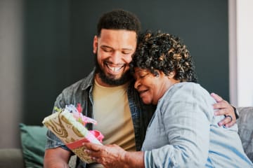 Man giving a gift to older woman
