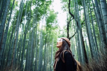 Woman taking in the beauty of God's creation in the forest 