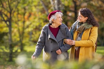 Woman listening to grandmother on walk