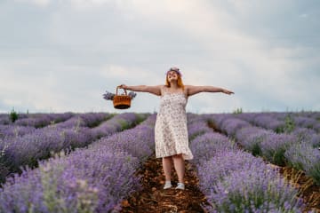 Woman celebrating God's creation in lavender field