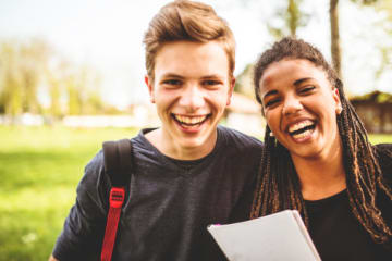 Two college students with cheerful hearts smiling