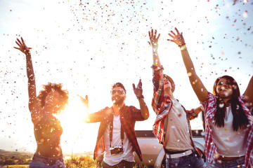 Friends celebrating and throwing confetti