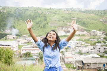 Girl lifting her hands in praise to God
