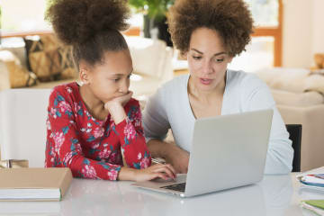 a mom helping her daughter with online homework