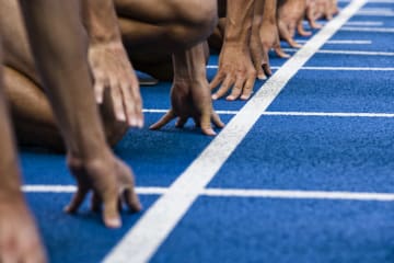 Athletes at the starting line of a racetrack