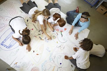 visual learners completing a large drawing together