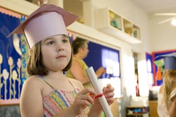 kindergarten graduate in paper cap