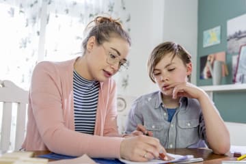 teacher tutoring student at the student's home