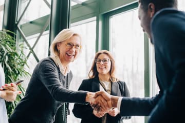 woman and man shaking hands