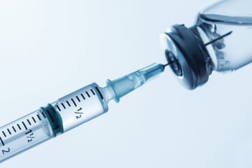 Hypodermic needle inside vaccine container