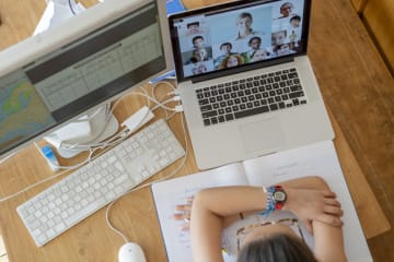 student attending class through a video call on a computer