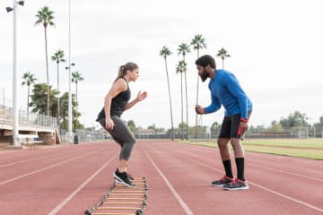 Athletic trainer degree graduate teaching a student