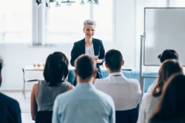 organizational leader running a meeting with their team