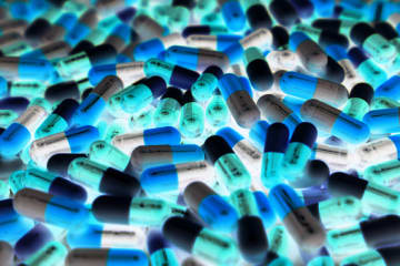 drug pills piled inside of a toxicology lab