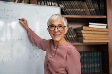 EdD degree instructor writing on whiteboard