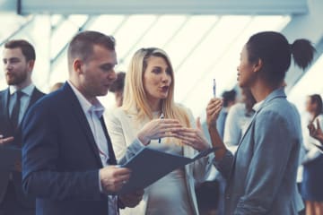 Male and female lobbyists talking with one another 