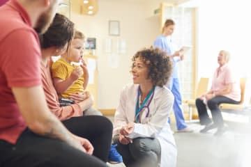 Family nurse practitioner talking with patients