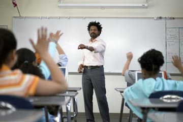 Male teacher in classroom with students