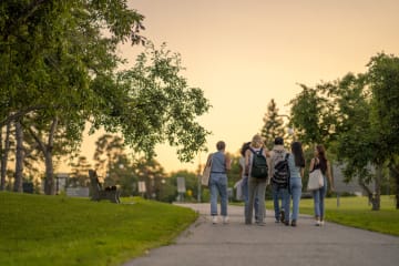 college students walking together on a sidewalk