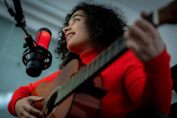 Young woman recording music