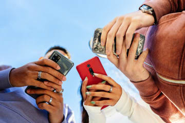 Teenagers interacting with phones