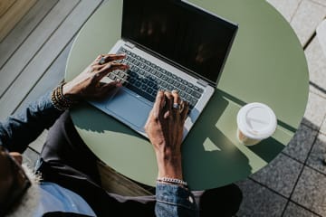 Man working on computer with coffee