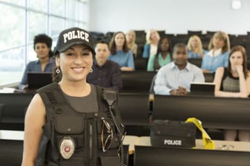 Female police officer in a classroom of students of the academy