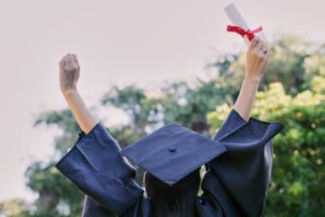 Graduation, education and success with a woman student holding a diploma or certificate in celebration outdoor. University, graduate and study with a female pupil cheering a college achievement - stock photo