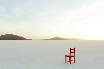 Red Chair on salt flats, facing the distance - stock photo