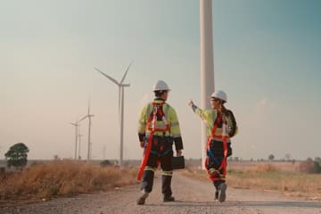 Two engineers checking out windmills.