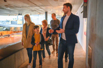 Historian giving a tour to a group of people in a museum