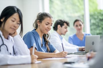 Doctors learning and working together - stock photo