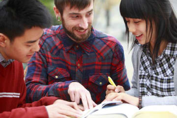 Students looking at a book