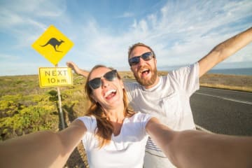 Kaitlyn posing in front of a sign in Australia