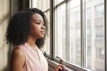 woman looking out a window