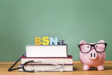 Piggy bank and books stacked