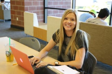 A student studying in the GCU library