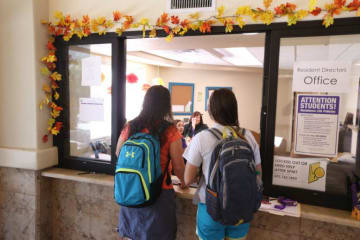 two students at an office window