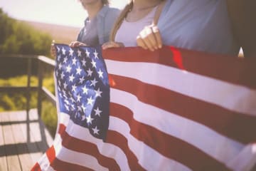 family holding american flag