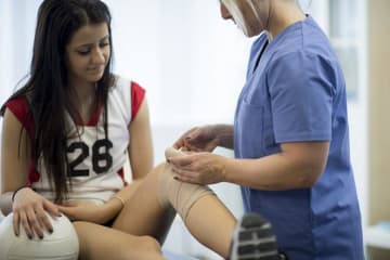 athletic trainer treating a patient